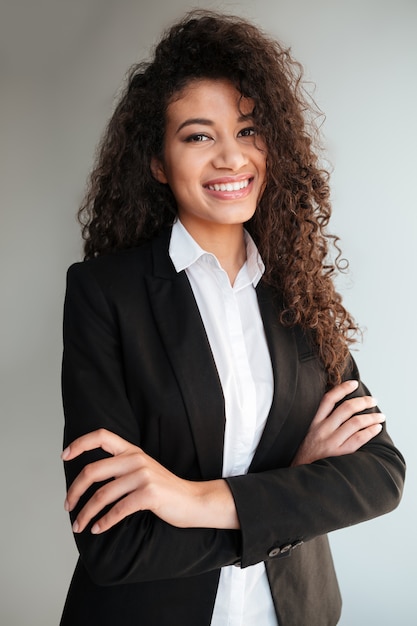 African business lady standing over grey background.