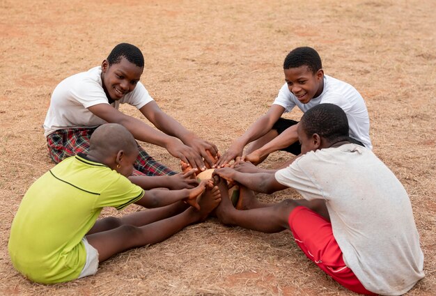 African children with football ball sitting