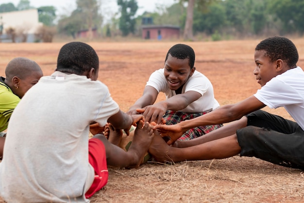 African children with football ball sitting