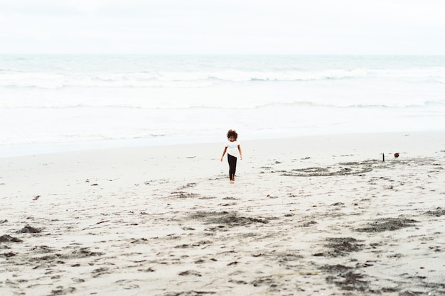 Free photo african girl having fun on the sandy beach