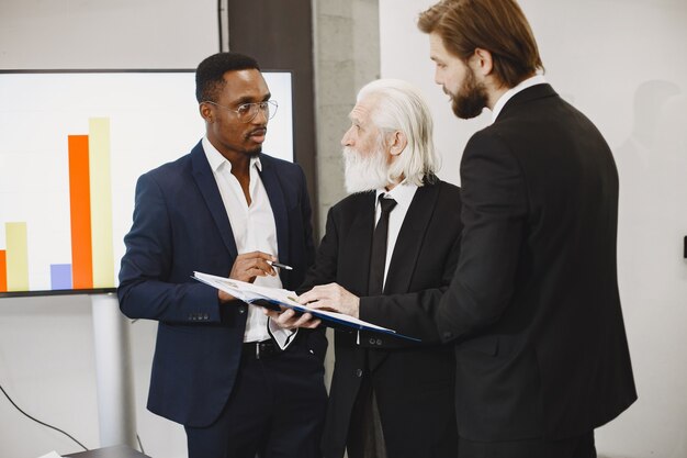 Free photo african man in a black suit. international partners.