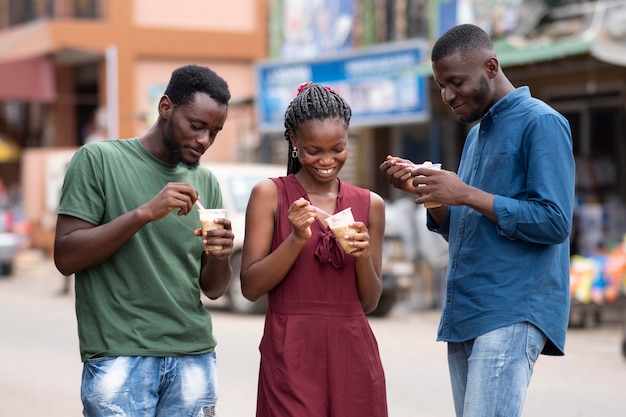 African people eating a cold beverage