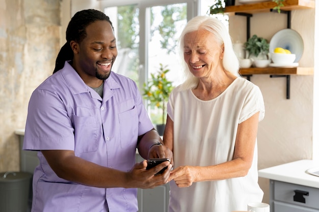 African social worker helping a senior woman