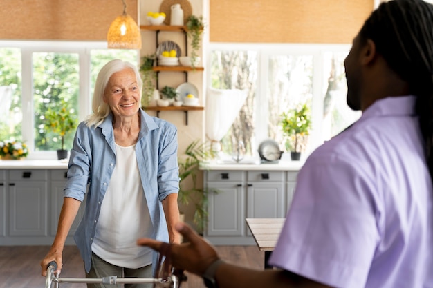 African social worker taking care of a senior woman