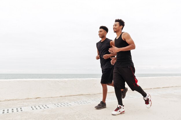 African sports men friends running outdoors