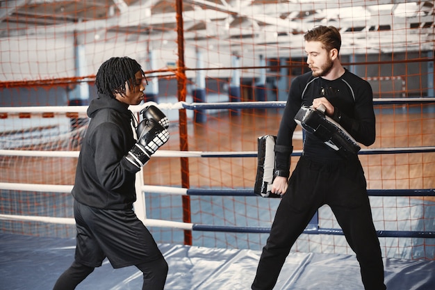 Free Photo african sporty man boxing. mixed people training.