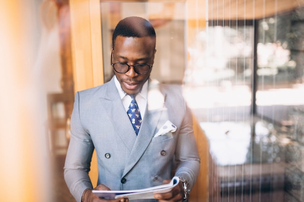 Afro american business man reading magazine