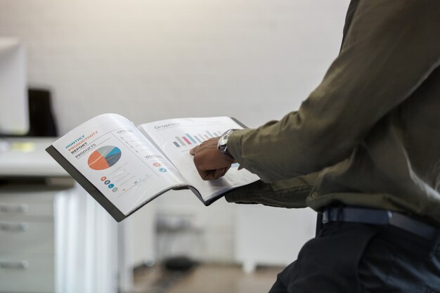 Afro american man pointing his finger at a graph