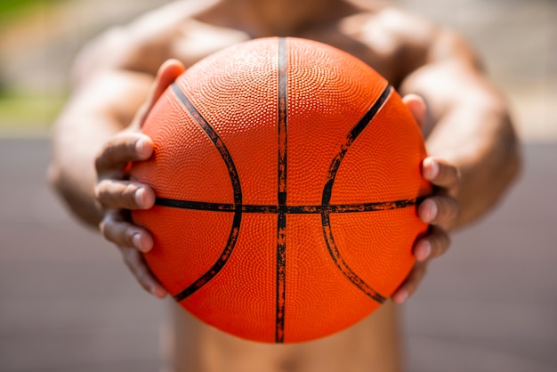 Free photo afro man holding a basketball ball