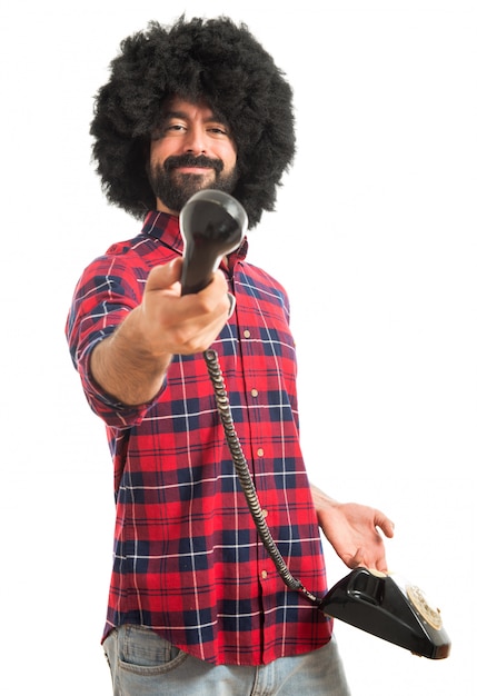 Afro man talking to vintage phone