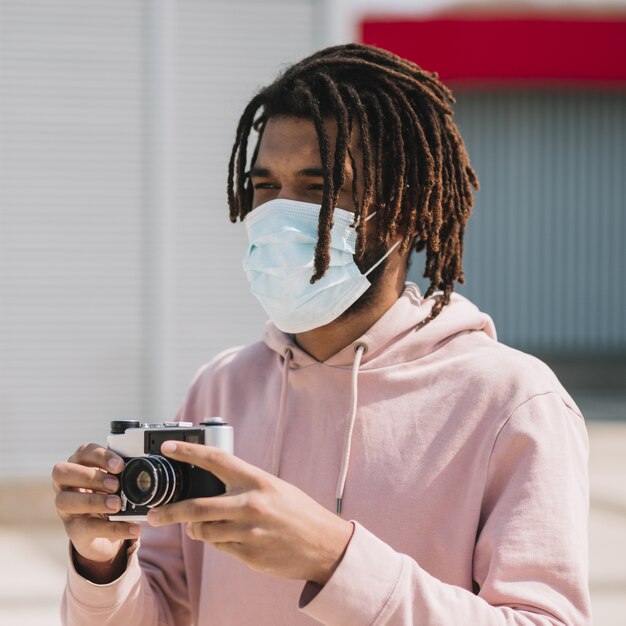 Afroamerican photographer wearing medical mask