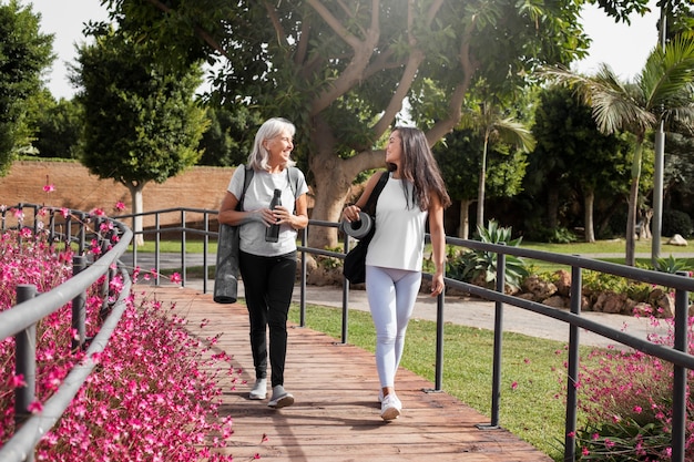 Free Photo age difference female friends meeting up for yoga outdoors