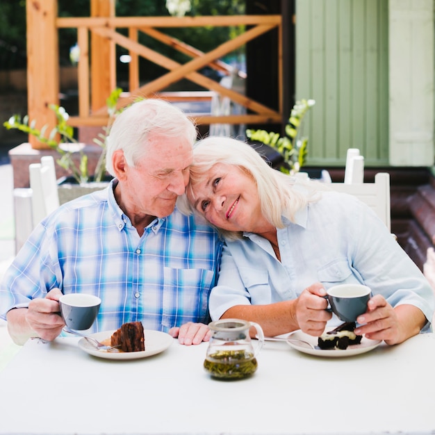 Aged couple enjoying time together drinking tea outdoors