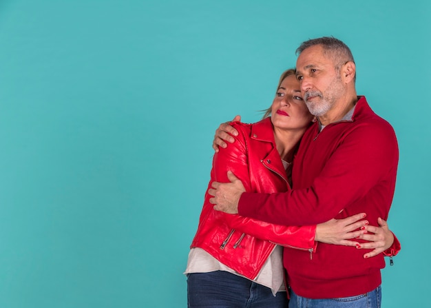 Aged man hugging with woman