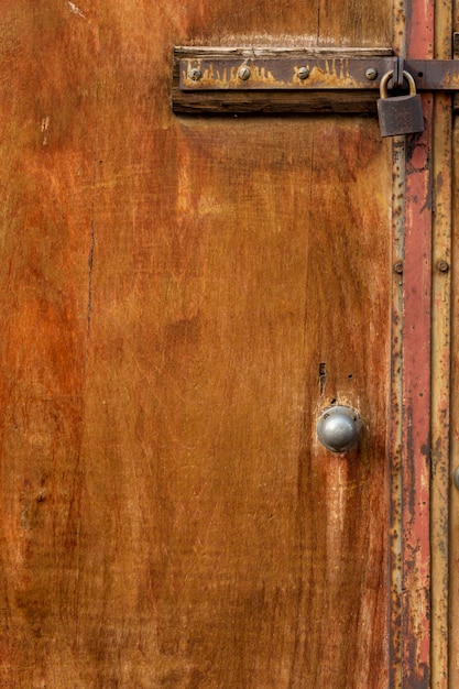 Aged wooden door with rusty metal lock