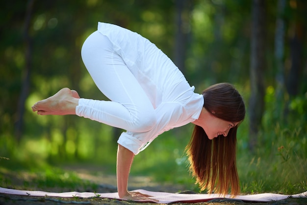 Agile woman stand on hands in yoga pose