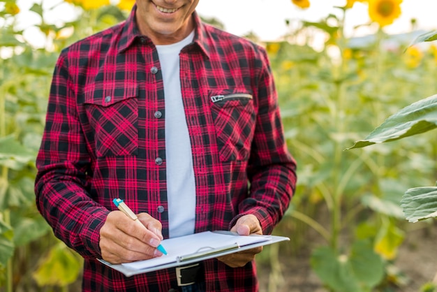 Agronomist signing on a clipboard