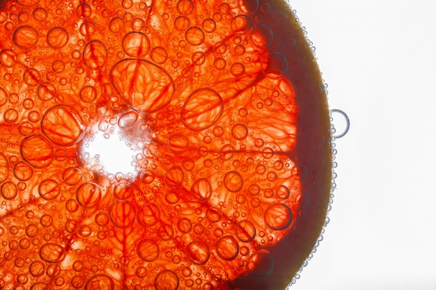 Air bubbles cover red fiber of grapefruit