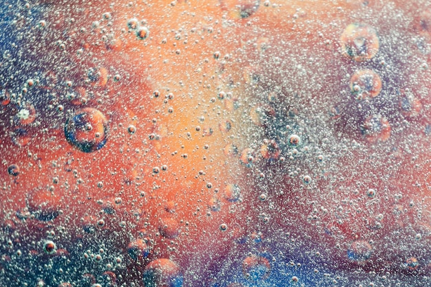 Free photo air bubbles splash in water on colorful background