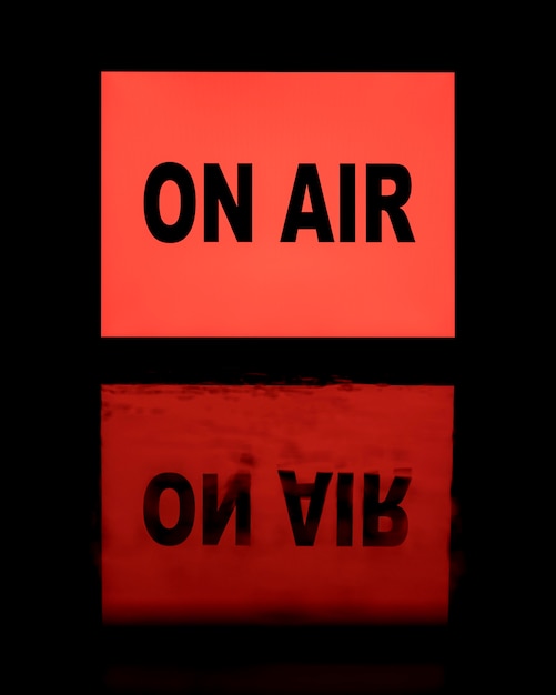 On air red neon light banner with reflection