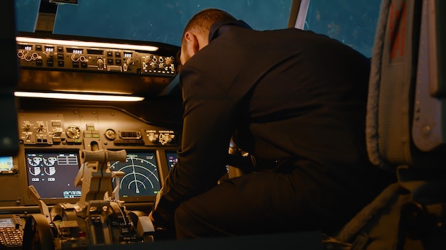 Aircraft captain using destination coordinates to fly airplane and takeoff on skyline, piloting airplane with control panel. Plane dashboard with power command and windscreen.