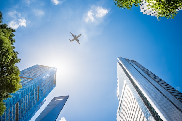 Airplane Flying Over Skyscrapers