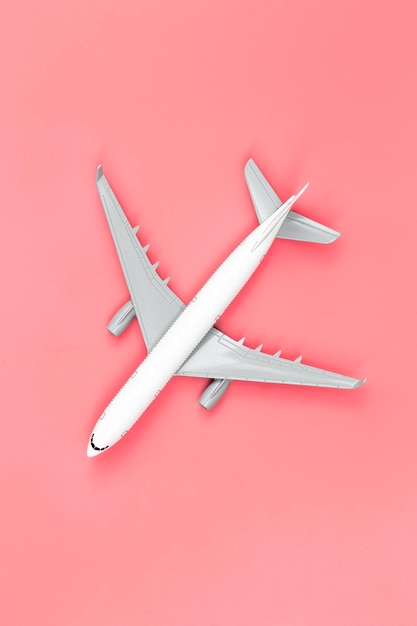 Airplane on a pink background flat lay travel concept