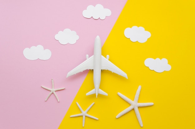 Free photo airplane toy with clouds above