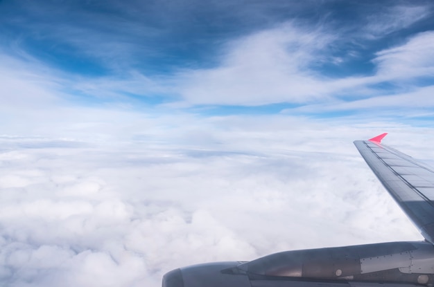 Free Photo airplane wing in the blue sky with clouds