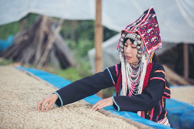 Free Photo akha women smiled and admired the coffee 