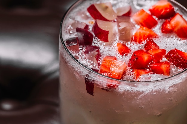 Free photo alcohol cocktail with berries strawberry grapes side view