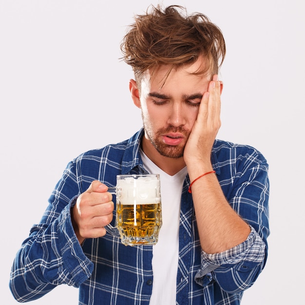 Alcohol. Guy in blue shirt with beer