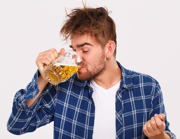 Alcohol. Guy in blue shirt with beer