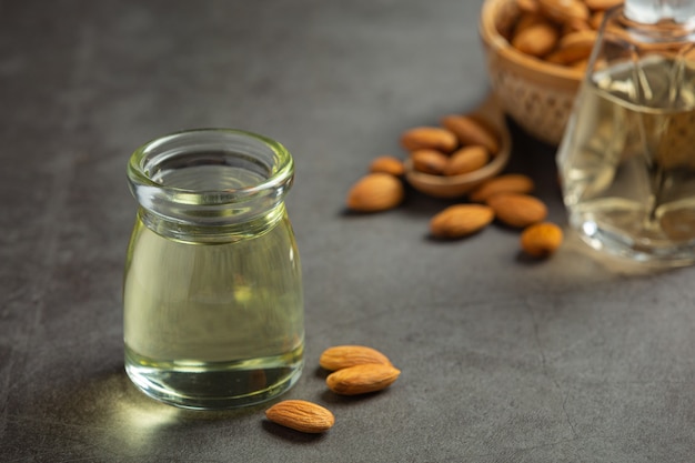 Free photo almond oil in bottle on dark background