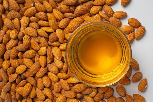 Almond oil in bottle on white background