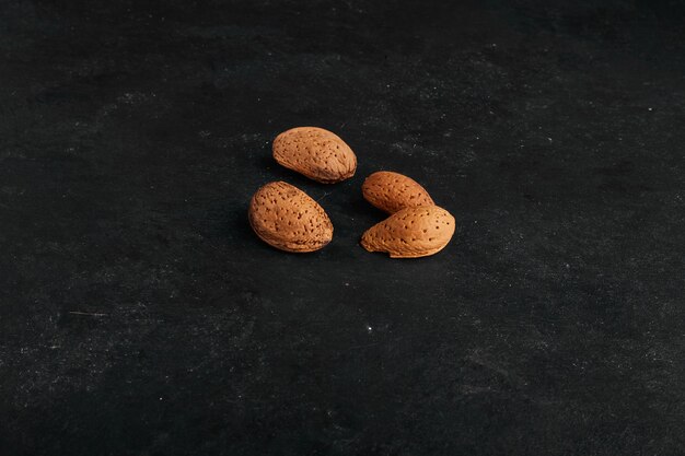 Almond shells isolated on black surface. 