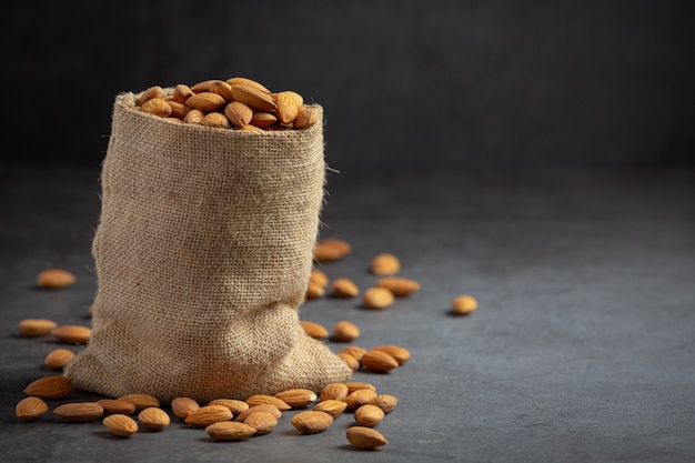 Free photo almonds in bag from sackingl on dark background