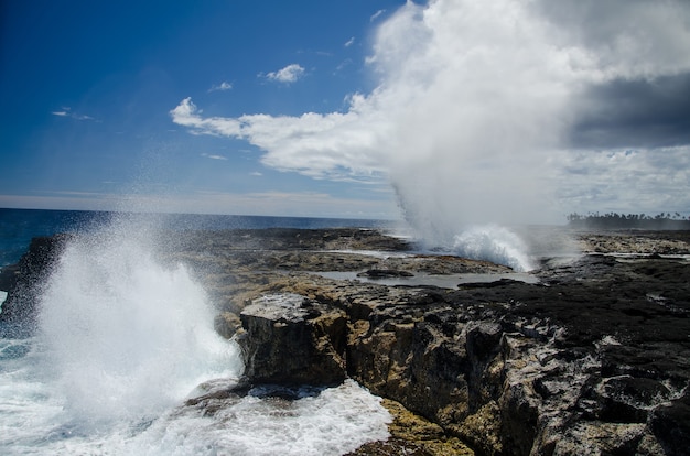 Alofaaga Blowholes under the sunlight and a blue cloudy sky in Samoa