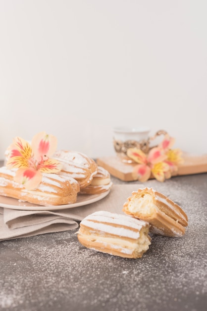 Alstroemeria flower on homemade eclairs against white backdrop