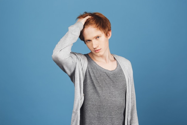 Am I beautiful and gorgeous enough, girl Portrait of self-confident young ginger teenager in casual outfit touching hair with hand,  with flirty and narcissistic expression.