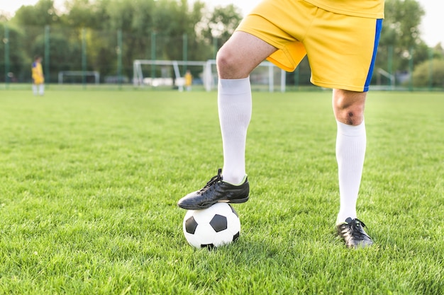 Amateur football concept with man posing with ball