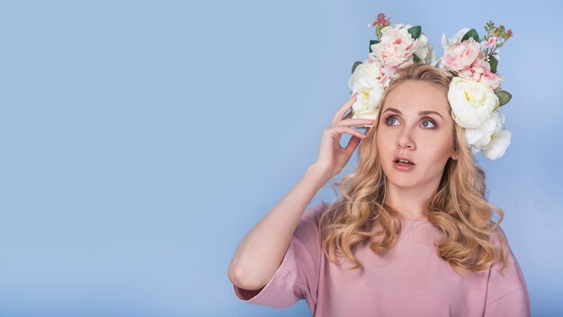 Amazed passionate lady with flowers on head