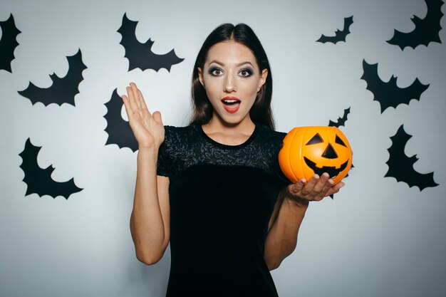 Amazed pretty girl with Halloween pumpkin