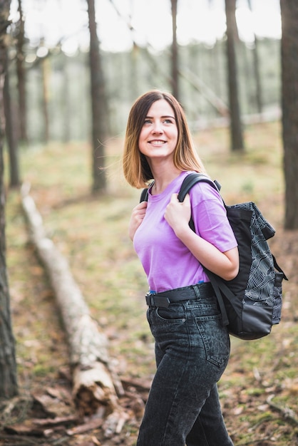 Amazed woman walking in forest