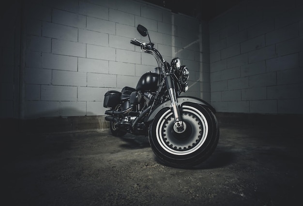 Amazing brand new motorbike is standing on the dark underground parking.