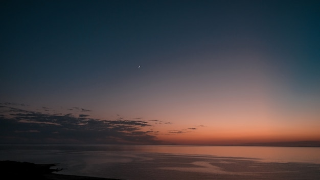 Free Photo amazing shot of a beautiful seascape on an orange sunset