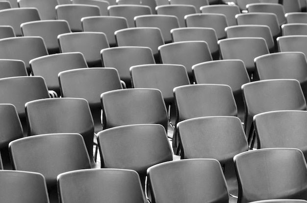 Free photo amazing shot of grey chairs perfectly placed in a row