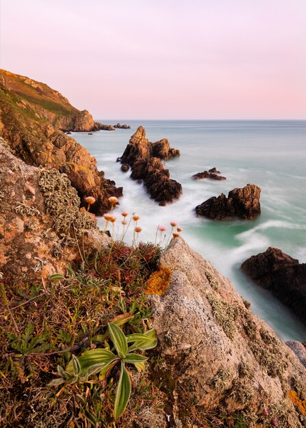 Amazing shot of a rocky beach in Jaonnet Bay on a sunset