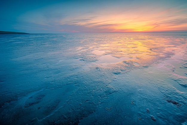 Free photo amazing shot of a seascape during a cold weather on sunset