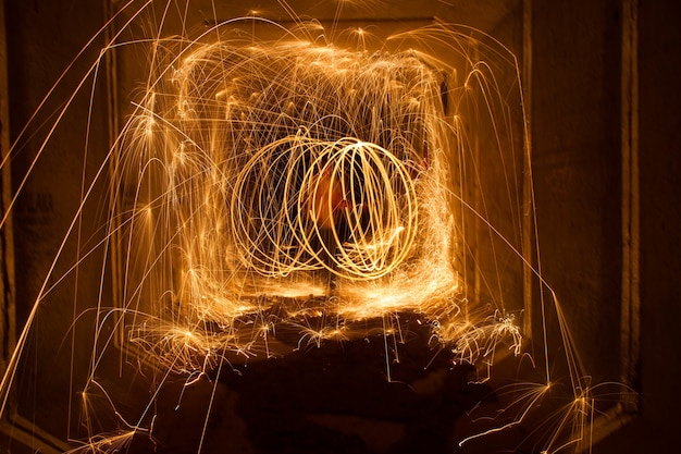 Free photo amazing steel wool fire circles at night with glowing sparks